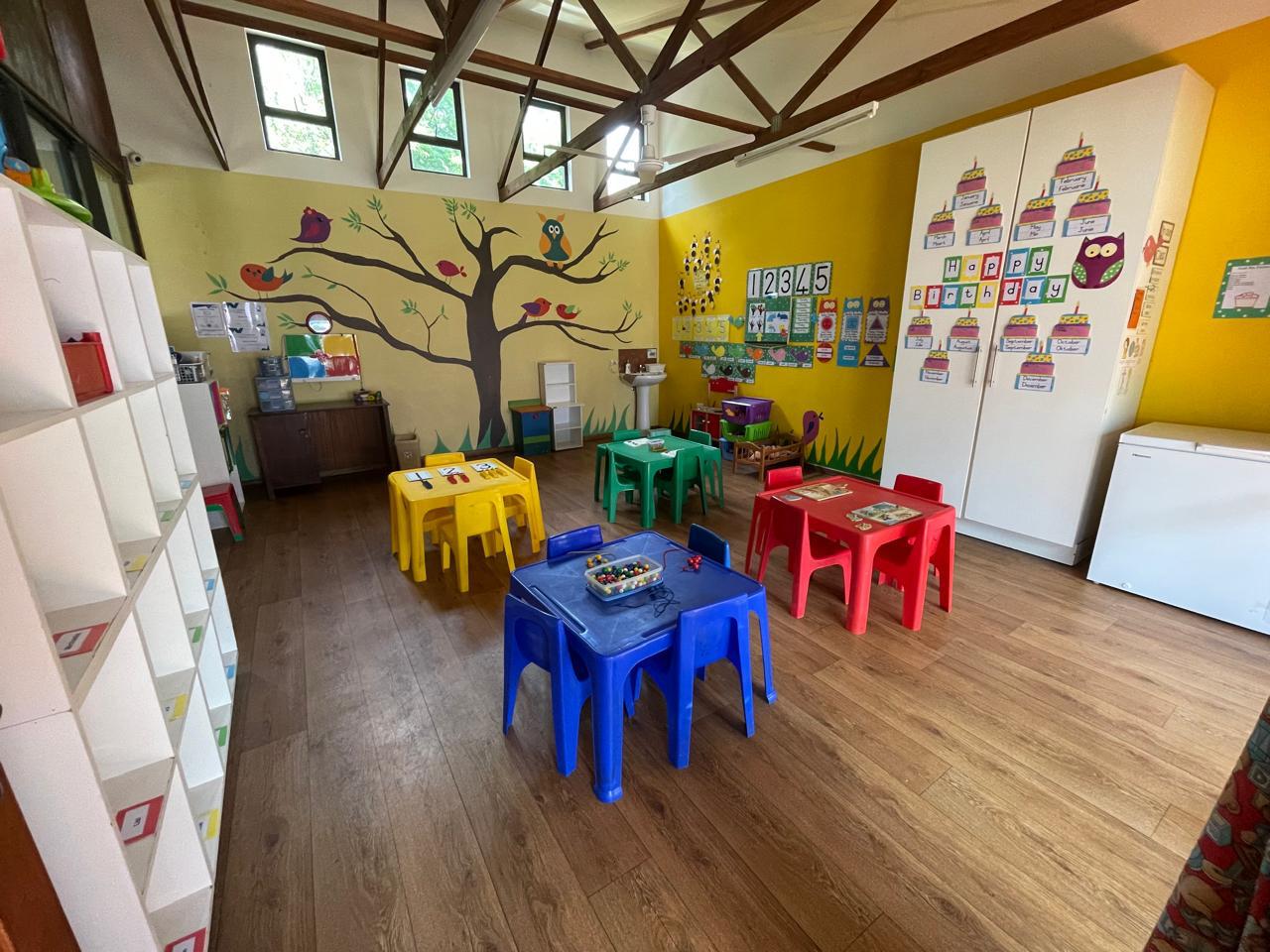 Children playing with wooden blocks in a sunny Little Stars Ruimsig classroom