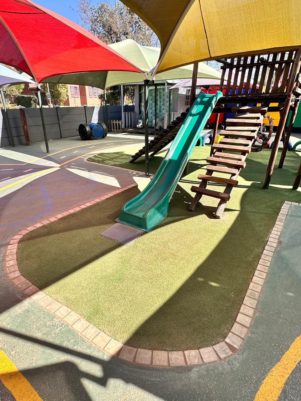 Green slide on soft lawn